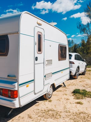 white-trailer-caravan-car-is-parked-on-the-side-of-road
